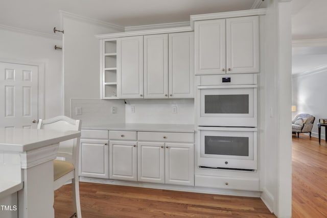 123 W Camden Forest Dr, Cary, NC 27518 - kitchen featuring double oven, open shelves, crown molding, light countertops, and backsplash