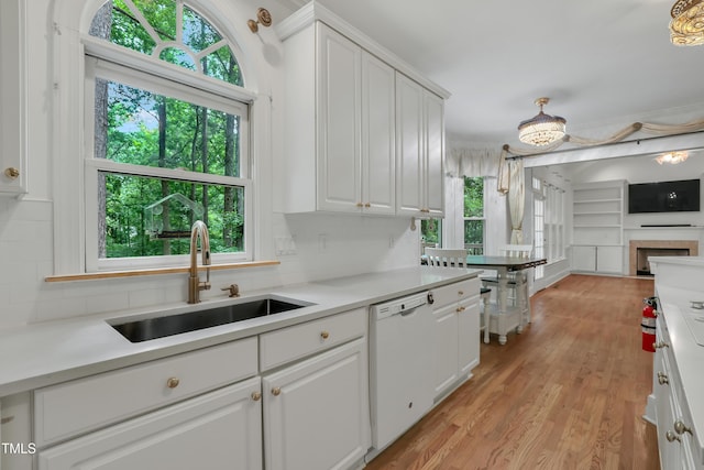 123 W Camden Forest Dr, Cary, NC 27518 - kitchen with a sink, dishwasher, white cabinets, light wood-style floors, and light countertops