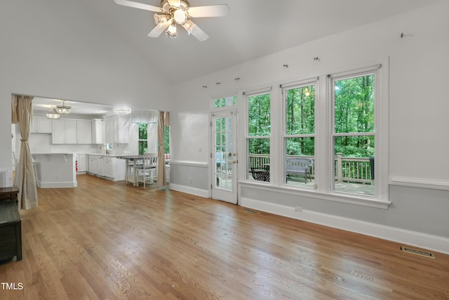 123 W Camden Forest Dr, Cary, NC 27518 - unfurnished living room with high vaulted ceiling, baseboards, a ceiling fan, and light wood finished floors