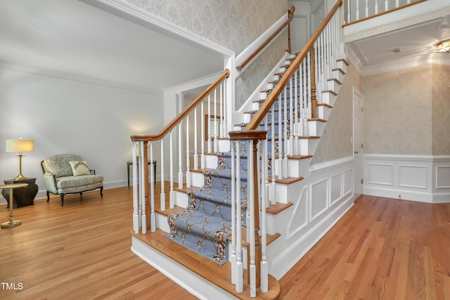 123 W Camden Forest Dr, Cary, NC 27518 - staircase with wood finished floors, crown molding, wainscoting, and wallpapered walls