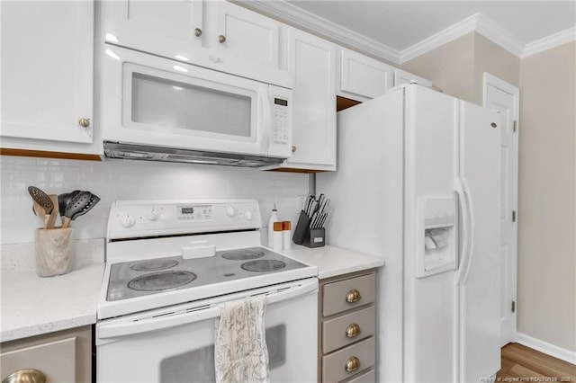 kitchen featuring white appliances, crown molding, white cabinetry, tasteful backsplash, and wood finished floors