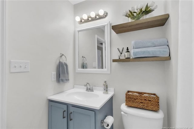 bathroom with toilet and vanity