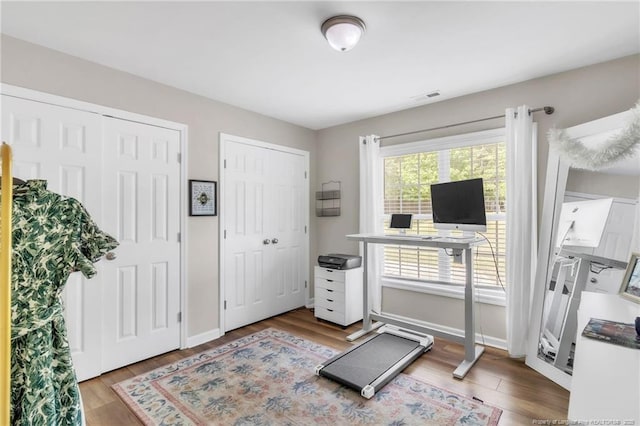 workout area with wood finished floors and baseboards