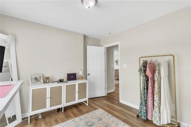 spare room with wood finished floors and baseboards