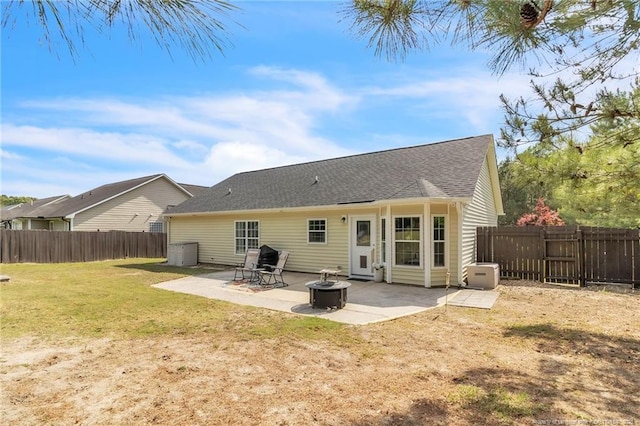 back of house with a patio and a shingled roof
