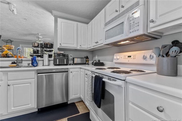 kitchen featuring white appliances, white cabinets, light countertops, and a textured ceiling