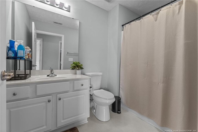 full bathroom featuring toilet, vanity, and a textured ceiling