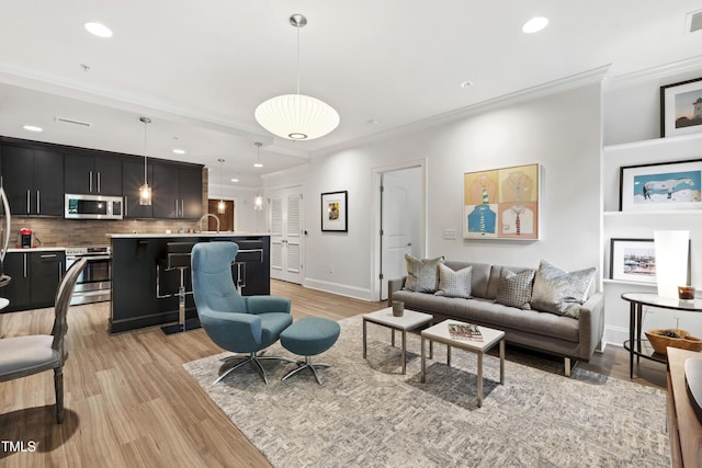 710 Independence Pl Unit 103, Raleigh, NC 27603 - living area featuring recessed lighting, crown molding, light wood-type flooring, and baseboards