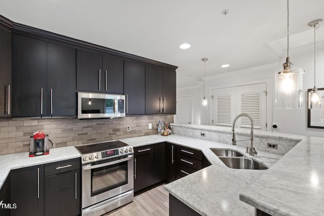 710 Independence Pl Unit 103, Raleigh, NC 27603 - kitchen with stainless steel appliances, a sink, crown molding, decorative light fixtures, and decorative backsplash