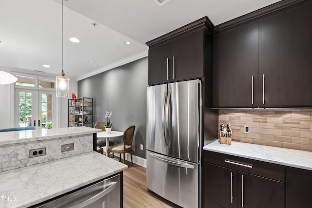 710 Independence Pl Unit 103, Raleigh, NC 27603 - kitchen with freestanding refrigerator, crown molding, light wood-type flooring, french doors, and backsplash