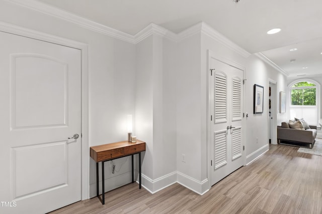 710 Independence Pl Unit 103, Raleigh, NC 27603 - hall with light wood finished floors, baseboards, recessed lighting, and crown molding