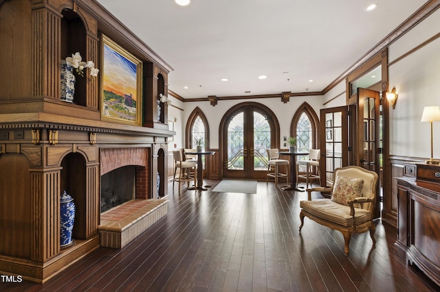710 Independence Pl Unit 103, Raleigh, NC 27603 - sitting room featuring french doors, crown molding, hardwood / wood-style floors, a fireplace, and recessed lighting