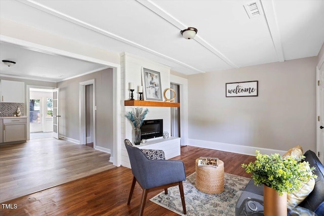 201 Van St, Pinetops, NC 27864 - living room featuring baseboards, a glass covered fireplace, and wood finished floors