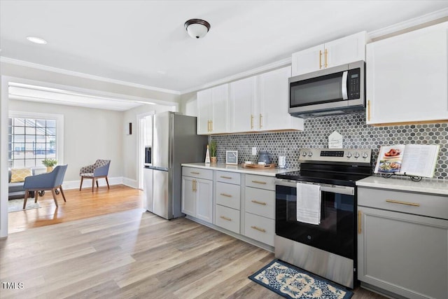 201 Van St, Pinetops, NC 27864 - kitchen featuring stainless steel appliances, gray cabinetry, light countertops, and ornamental molding