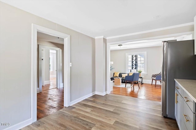 201 Van St, Pinetops, NC 27864 - kitchen with freestanding refrigerator, ornamental molding, light wood-style floors, light countertops, and baseboards
