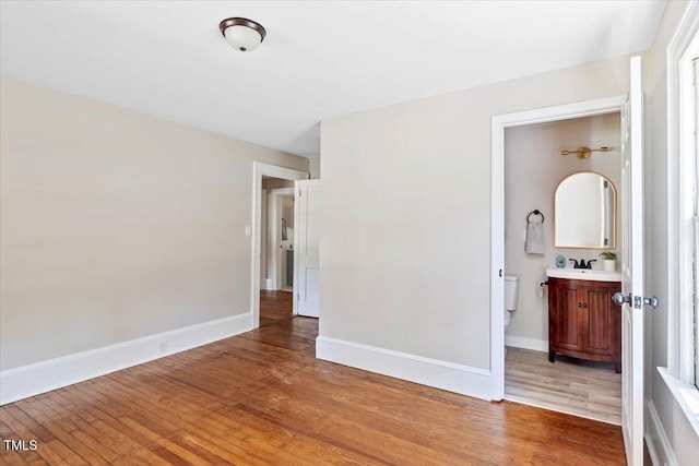 201 Van St, Pinetops, NC 27864 - unfurnished bedroom with light wood-style floors, baseboards, and a sink