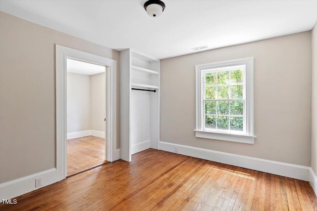 201 Van St, Pinetops, NC 27864 - unfurnished bedroom with wood-type flooring, a closet, and baseboards