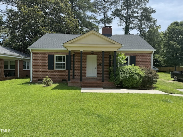 905 S 1st St, Smithfield, NC 27577 - view of front of house featuring brick siding, a chimney, a front yard, roof with shingles, and crawl space