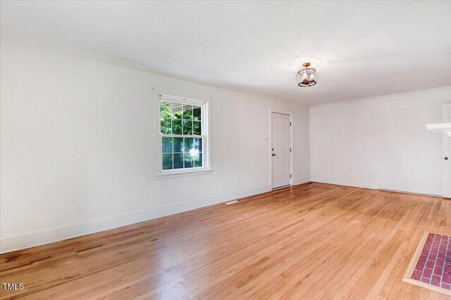 905 S 1st St, Smithfield, NC 27577 - spare room featuring crown molding, light wood-style flooring, baseboards, and a chandelier