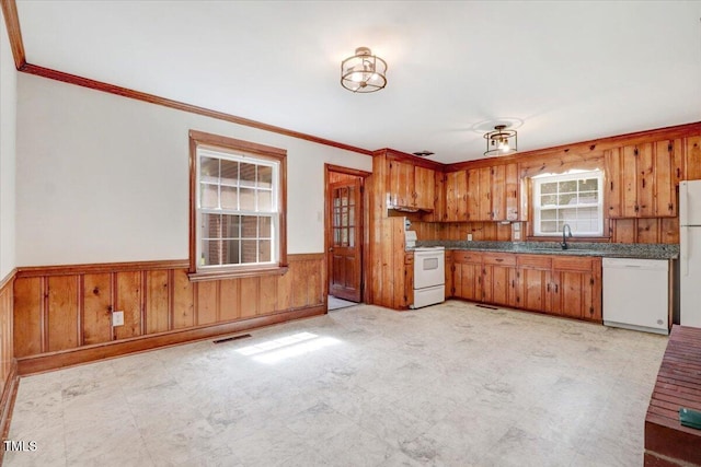 905 S 1st St, Smithfield, NC 27577 - kitchen with white appliances, a sink, crown molding, wainscoting, and brown cabinetry