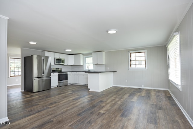 107 Rencher St, Hillsborough, NC 27278 - kitchen with appliances with stainless steel finishes, baseboards, crown molding, a sink, and dark countertops
