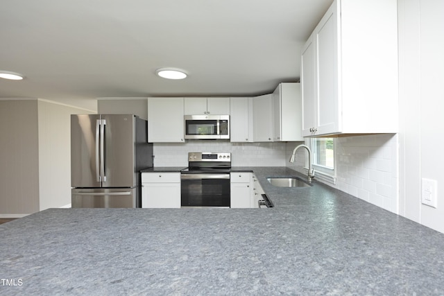 107 Rencher St, Hillsborough, NC 27278 - kitchen with stainless steel appliances, a sink, dark countertops, backsplash, and white cabinetry