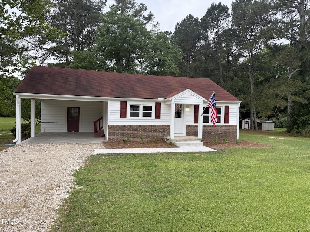 6300 NC-27, Coats, NC 27521 - view of front of property with driveway, a carport, a front lawn, and brick siding