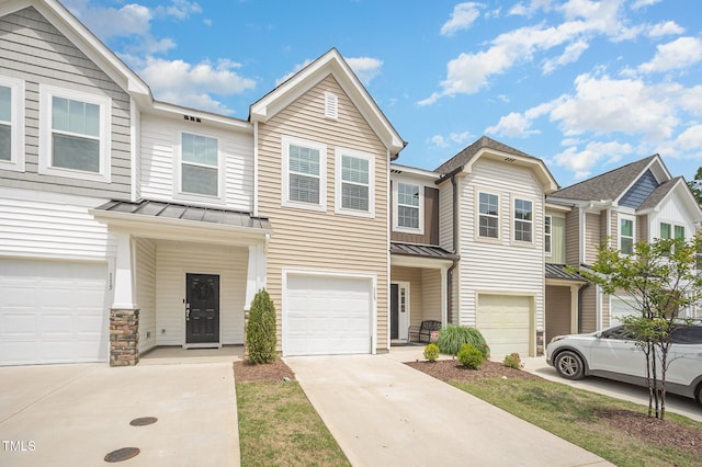 113 Blandford St, Franklinton, NC 27525 - townhome / multi-family property featuring a standing seam roof, a garage, concrete driveway, and metal roof