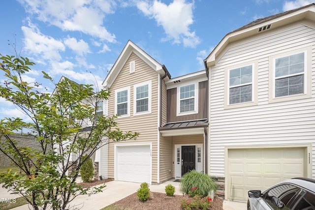 113 Blandford St, Franklinton, NC 27525 - townhome / multi-family property featuring an attached garage, a standing seam roof, metal roof, and driveway