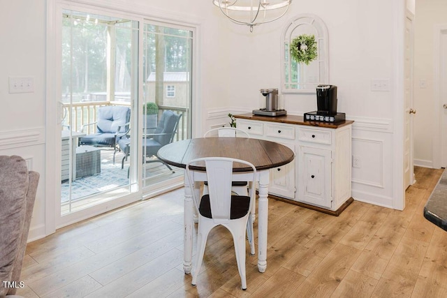 176 Lowery Ln, Benson, NC 27504 - dining room with light wood-style floors, wainscoting, and a decorative wall