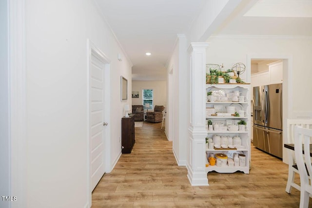 176 Lowery Ln, Benson, NC 27504 - hallway featuring decorative columns, ornamental molding, light wood-style flooring, and recessed lighting