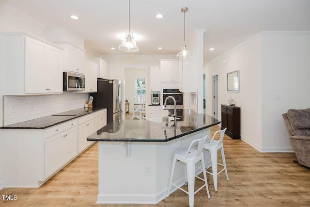 176 Lowery Ln, Benson, NC 27504 - kitchen featuring stainless steel appliances, a breakfast bar area, a sink, ornamental molding, and white cabinets