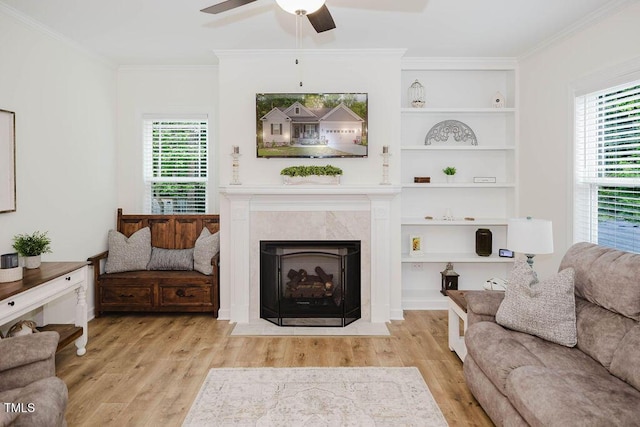 176 Lowery Ln, Benson, NC 27504 - living area with wood finished floors, ceiling fan, crown molding, and plenty of natural light