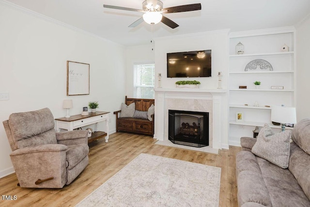 176 Lowery Ln, Benson, NC 27504 - living area featuring a ceiling fan, wood finished floors, a high end fireplace, and crown molding