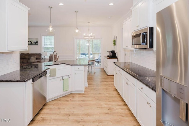 176 Lowery Ln, Benson, NC 27504 - kitchen featuring appliances with stainless steel finishes, a sink, light wood finished floors, white cabinetry, and recessed lighting