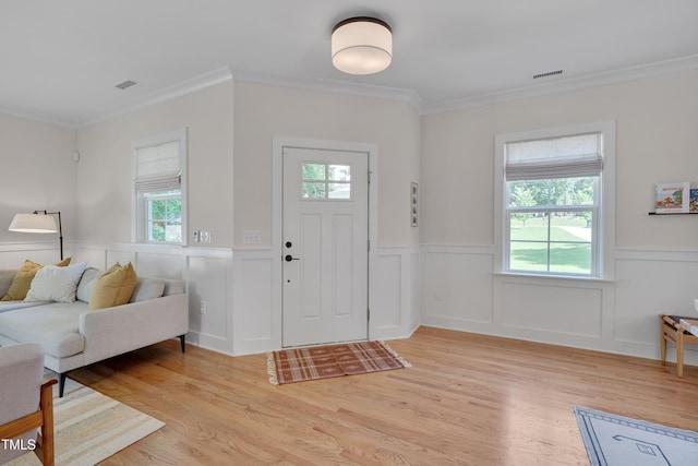 3003 University Dr, Durham, NC 27707 - entrance foyer with a wainscoted wall, light wood-style floors, crown molding, and a decorative wall