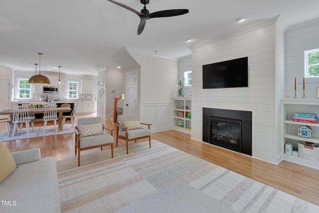 3003 University Dr, Durham, NC 27707 - living area with light wood-style floors, a ceiling fan, crown molding, recessed lighting, and healthy amount of natural light