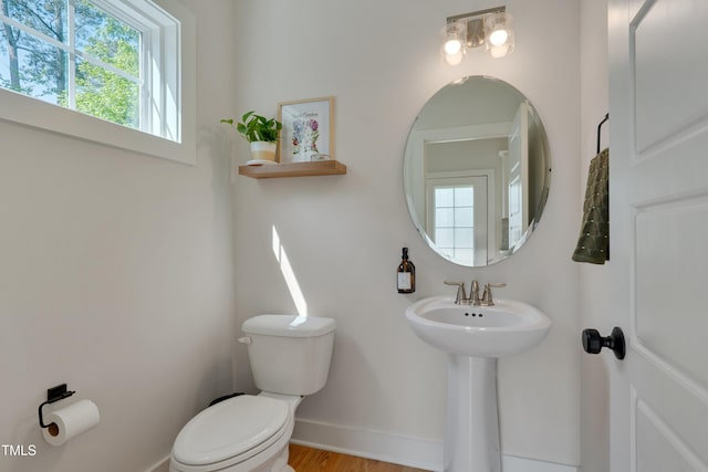 3003 University Dr, Durham, NC 27707 - half bathroom with toilet, baseboards, wood finished floors, and a sink