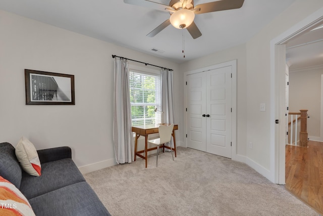 3003 University Dr, Durham, NC 27707 - living area featuring a ceiling fan, baseboards, and light carpet
