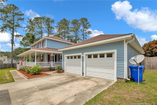 view of front facade with a porch, concrete driveway, an attached garage, and a shingled roof