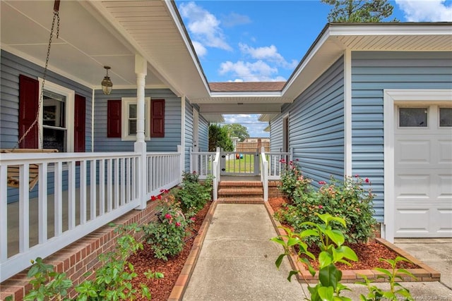 covered porch with an attached garage