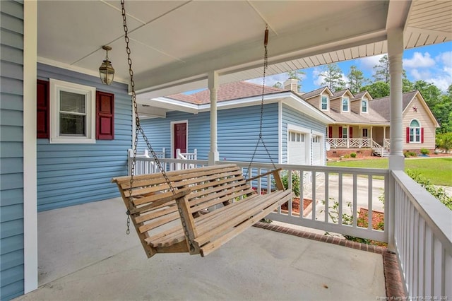 covered porch with a garage