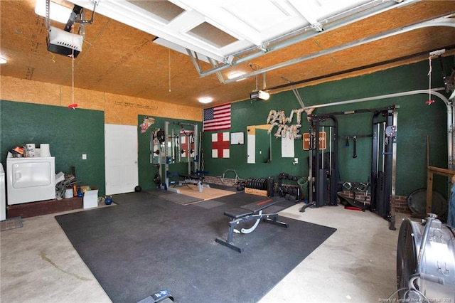 exercise area with washer / dryer and a garage