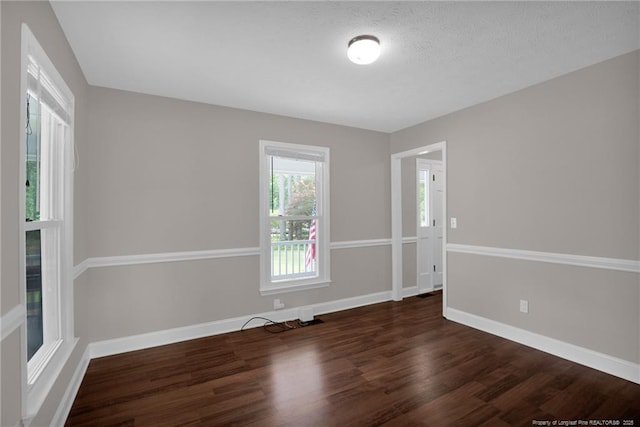 unfurnished room featuring wood finished floors and baseboards