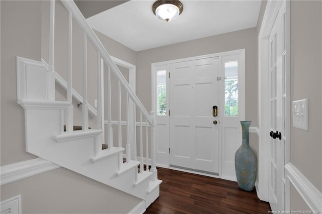 entryway featuring stairway and dark wood-type flooring