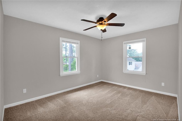 unfurnished room with carpet, a ceiling fan, and baseboards