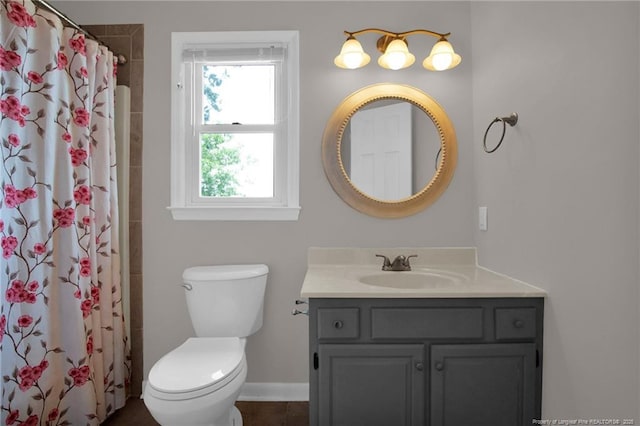 bathroom featuring vanity, toilet, a shower with curtain, and baseboards