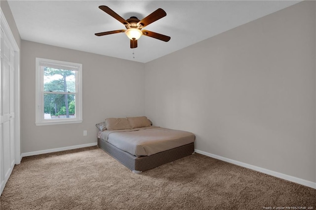 carpeted bedroom with baseboards and a ceiling fan