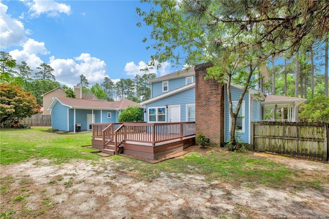 back of house with a deck