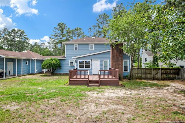 back of property with a deck and a chimney